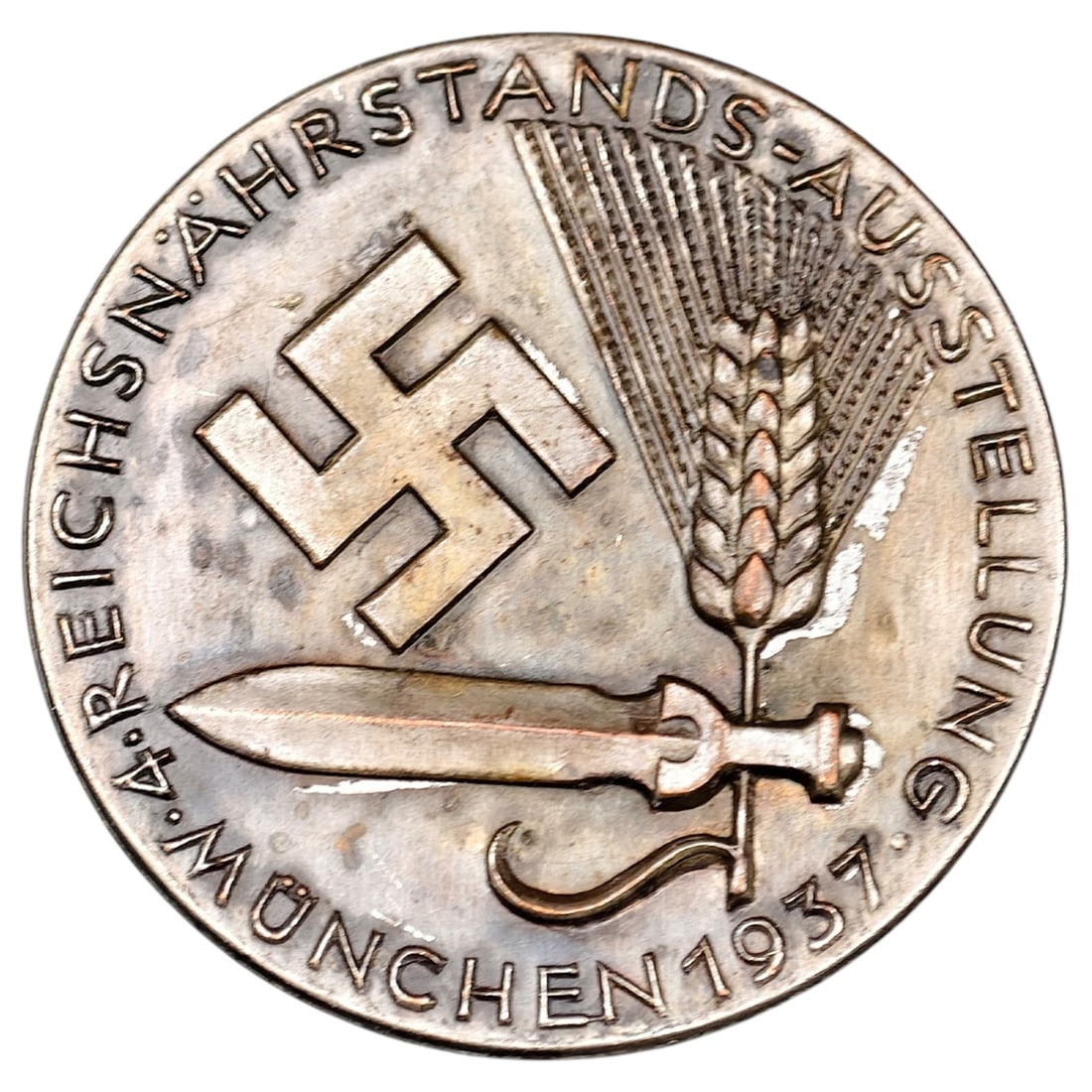 Third Reich 4. Reichsnährstands-Ausstellung München 1937 Tinnie Badge by Deschler & Sohn: A round tinnie/badge commemorating the 4th Reich Food Estate Exhibition (Reichsnährstands-Ausstellung) held in Munich in 1937, featuring a swastika, wheat sheaf, and sickle design with surrounding in
