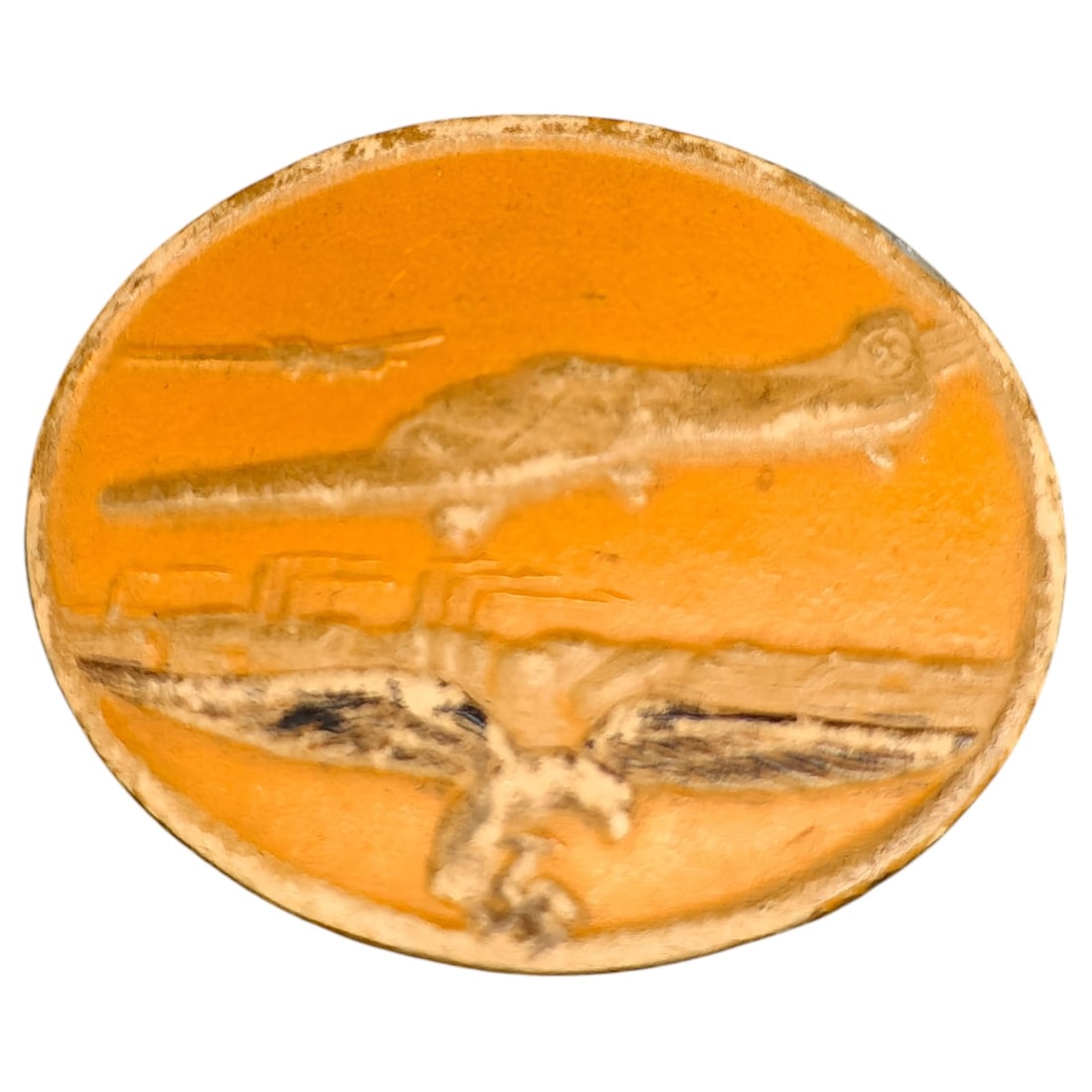 Third Reich Luftwaffe Factory Tinnie Badge: A painted tin (tinnie) badge depicting a stylized bomber aircraft in flight over an airfield with a swastika visible on the tail, an eagle in flight below, and a smaller aircraft in the background aga