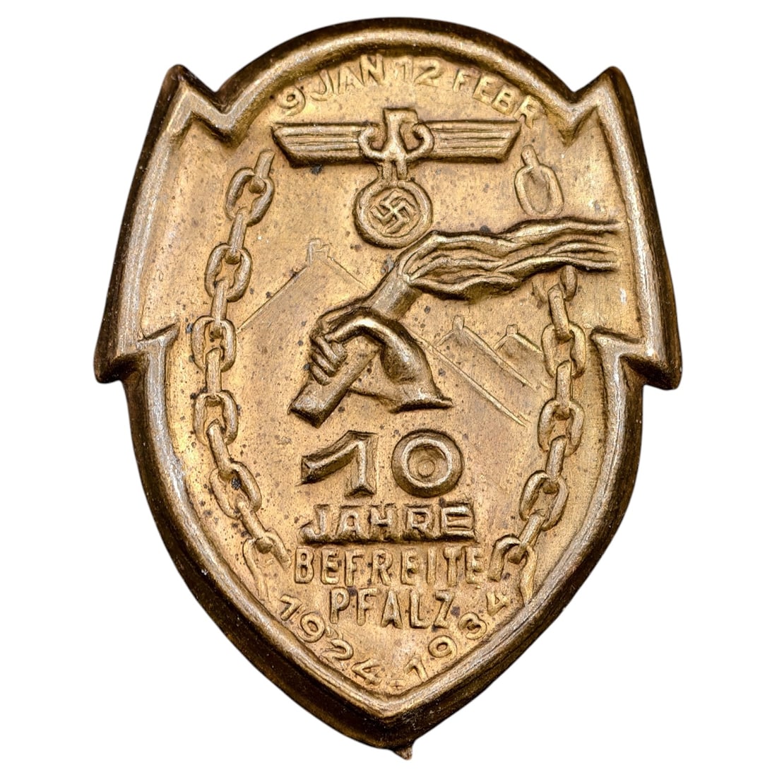 Third Reich Nazi 10 Year 1934 Tinnie Badge: A shield-shaped commemorative badge marking the 10th anniversary of the liberation of the Pfalz (Palatinate) region, dated 1924-1934. The obverse depicts a Reichsadler with swastika above a torch-bear