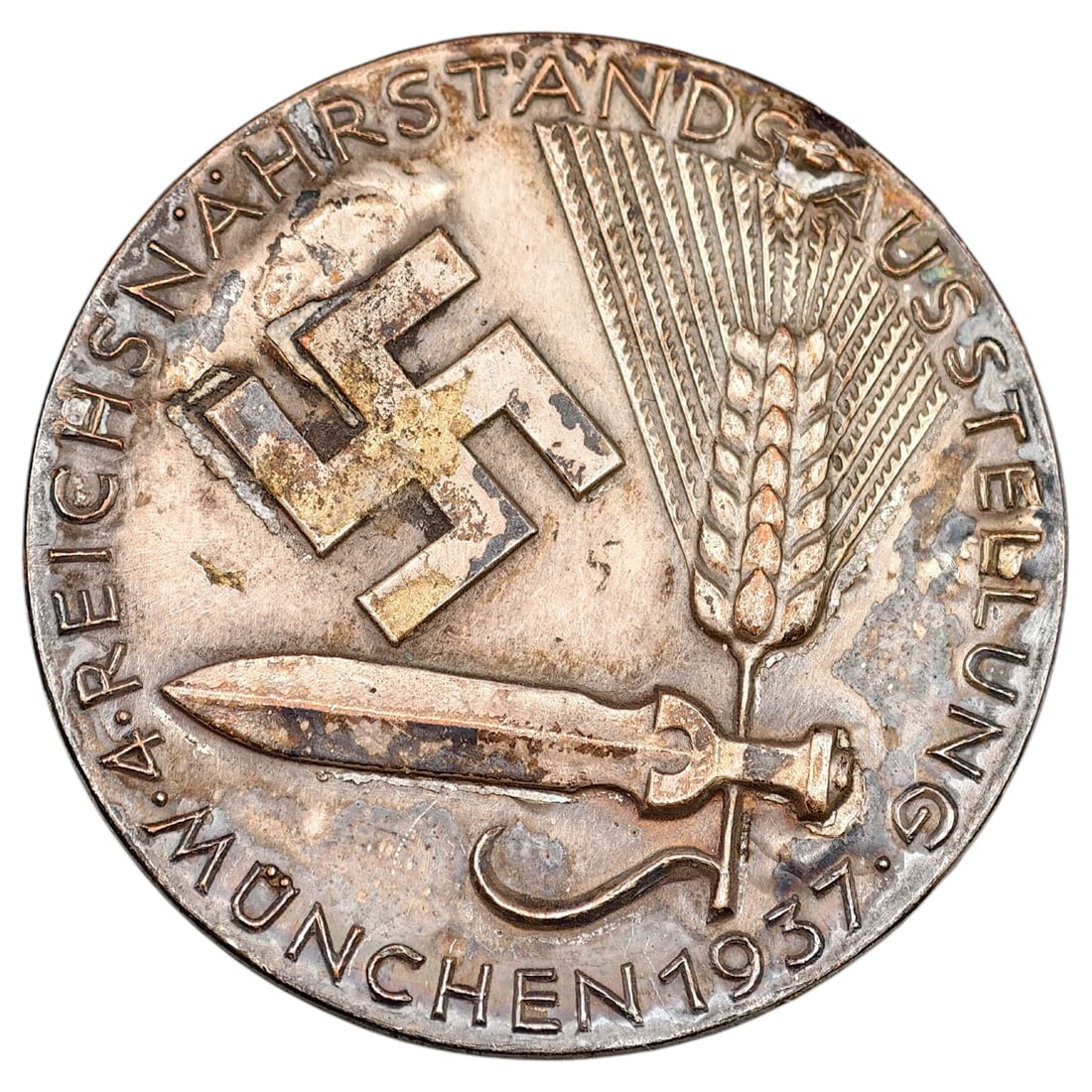 Third Reich Reichsnährstands Ausstellung München 1937 Tinnie: A commemorative tinnie badge marking the '4. Reichsnährstands Ausstellung München 1937' (4th Reich Food Estate Exhibition, Munich 1937), featuring a swastika, sheaf of wheat, and sword design. The r