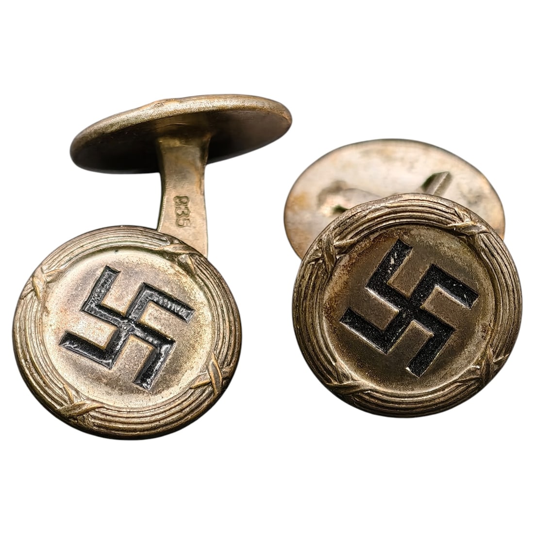 Third Reich Nazi NSDAP Cufflinks 835 Silver: A pair of double-sided cufflinks, each face die-stamped with a raised mobile swastika within a rope/wheat-sheaf border, the recessed background finished in a dark tone for contrast. The reverse of