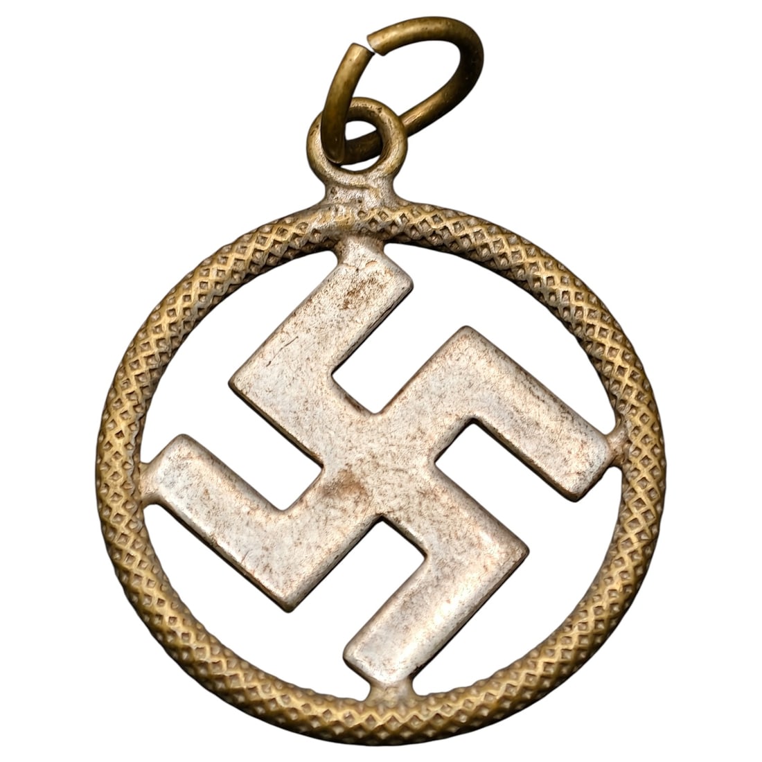 Third Reich Swastika Nazi Sympathizer Necklace Medallion: A round pendant featuring a raised swastika in what appears to be a silver tone at center within an outer ring in what appears to be a brass tone, decorated with a textured cross-hatch pattern. The pi