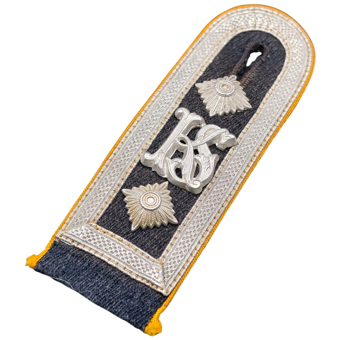 Imperial German Cavalry Officer's Shoulder Board with Cypher Monogram: A single officer's shoulder board (Schulterstück) constructed of grey wool backing with braid trim in what appears to be silver bullion and yellow piping, indicating a cavalry or dragoon regiment. Th