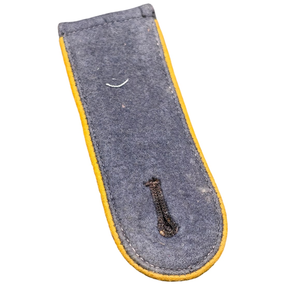 German WWII Heer Enlisted Man's Shoulder Board - Yellow Piping: Single enlisted man's shoulder board (Schulterklappe) for the German Army, constructed of field-grey wool with yellow branch-color piping denoting a signals/cavalry-related branch. The underside is a 