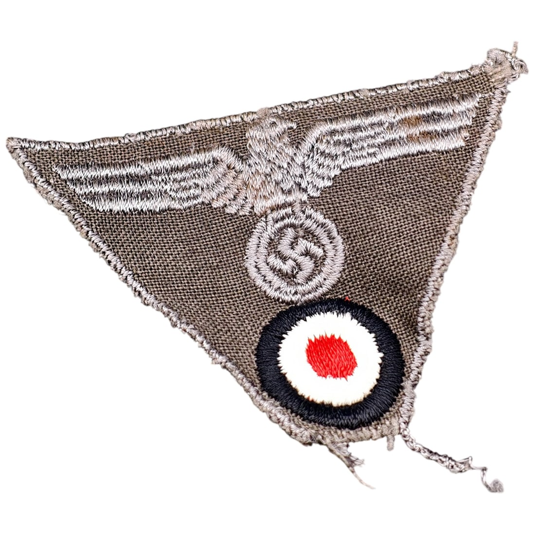 German WWII Nazi Heer Trapezoid Cockade Cap Insignia: A bevo-woven triangular/trapezoid cap insignia for German Army field cap, combining a machine-embroidered Wehrmacht eagle clutching a swastika above a national tri-color cockade (black, white, red). W