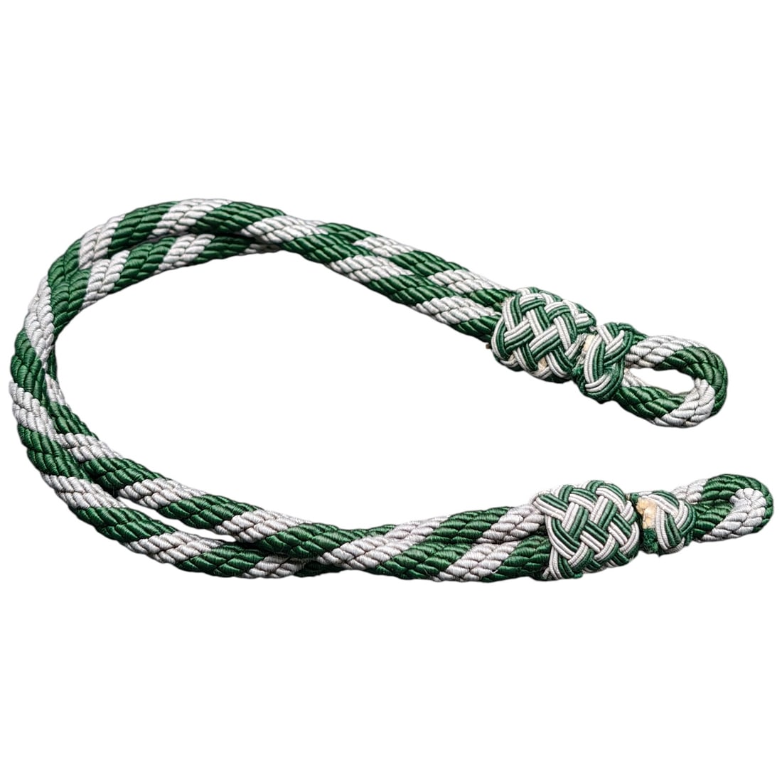 German WWII Wehrmacht Visor Cap Cord: A twisted cord in green and white, likely intended for a visor/peaked cap, terminating in two woven knot ends. Constructed of twisted rayon or cotton-blend threads. No maker marks or paper tags visibl