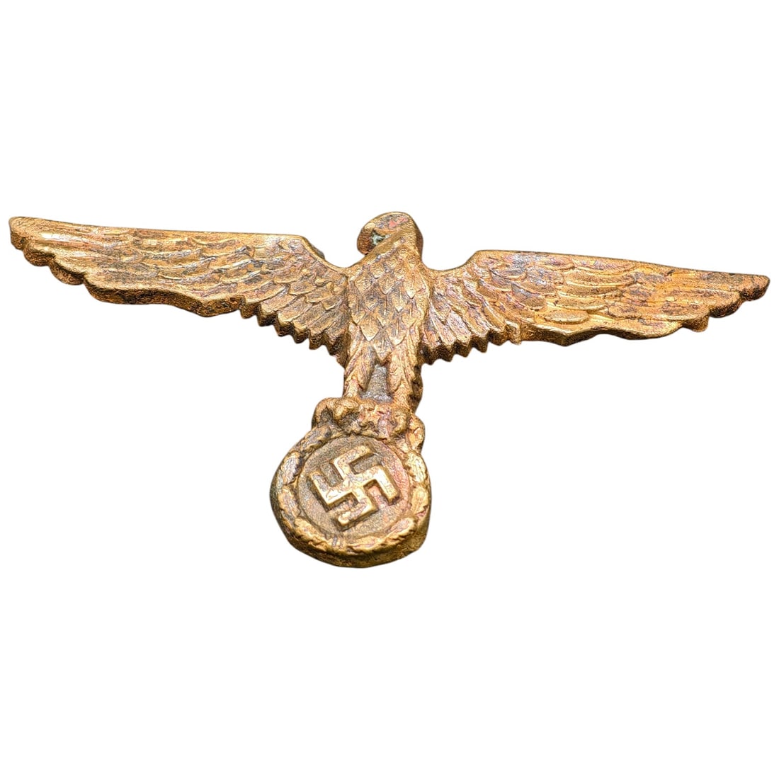 German WWII Kriegsmarine Tropical Pith Helmet Eagle: A metal spread-wing eagle clutching a wreathed swastika, designed as an applique for a Kriegsmarine tropical pith helmet. The piece shows a textured feather pattern and a granular cast surface