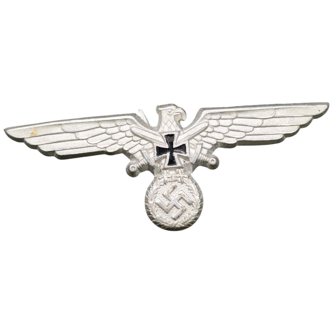 German WWII Veterans Association Cap Visor Eagle Insignia: A stamped metal eagle badge with outstretched wings, clutching a wreathed swastika device below crossed swords and an Iron Cross emblem.