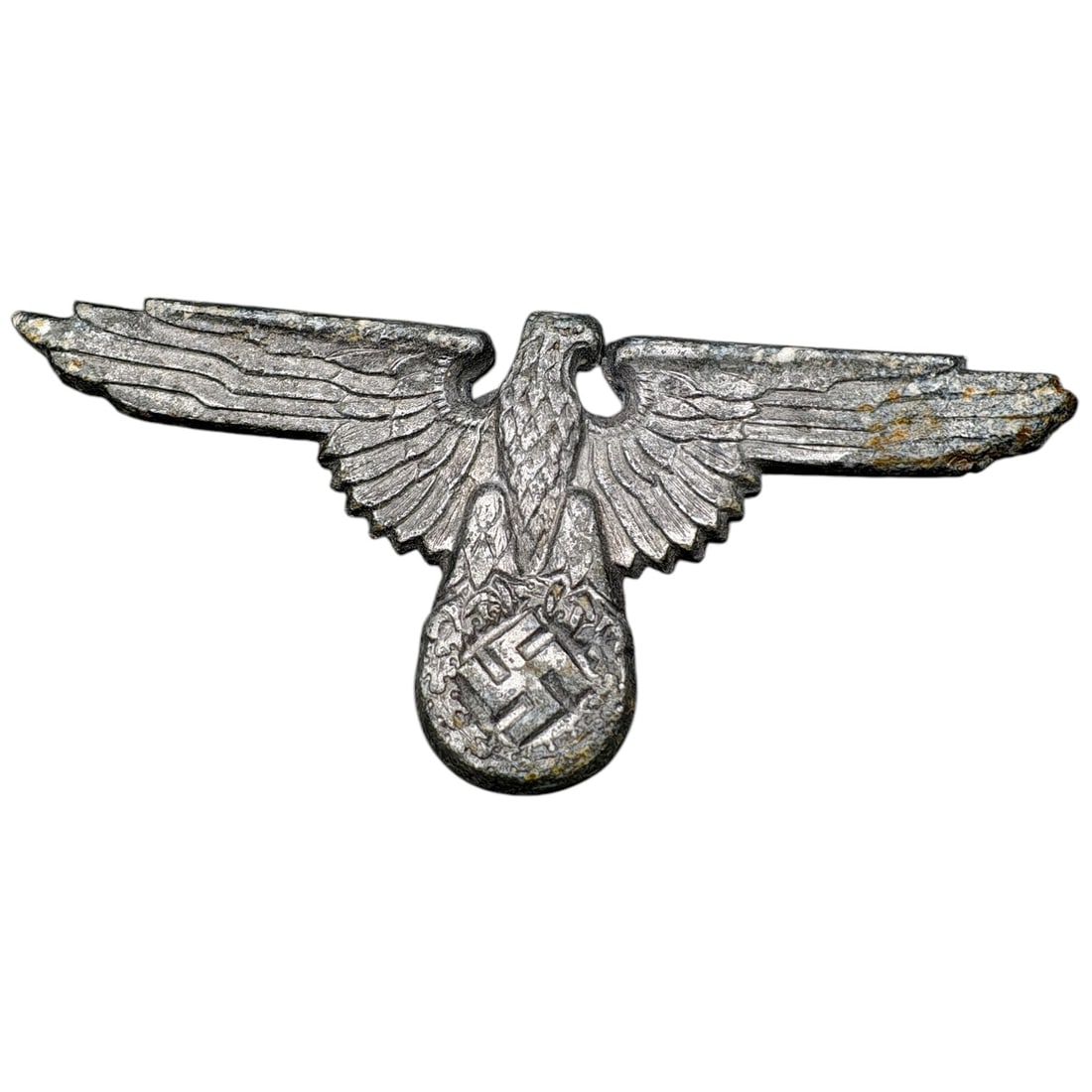 Third Reich SS Visor Eagle Insignia: A metal cap eagle insignia (Hoheitszeichen) for an SS visor cap, depicting an eagle with outstretched wings clutching a wreathed swastika.