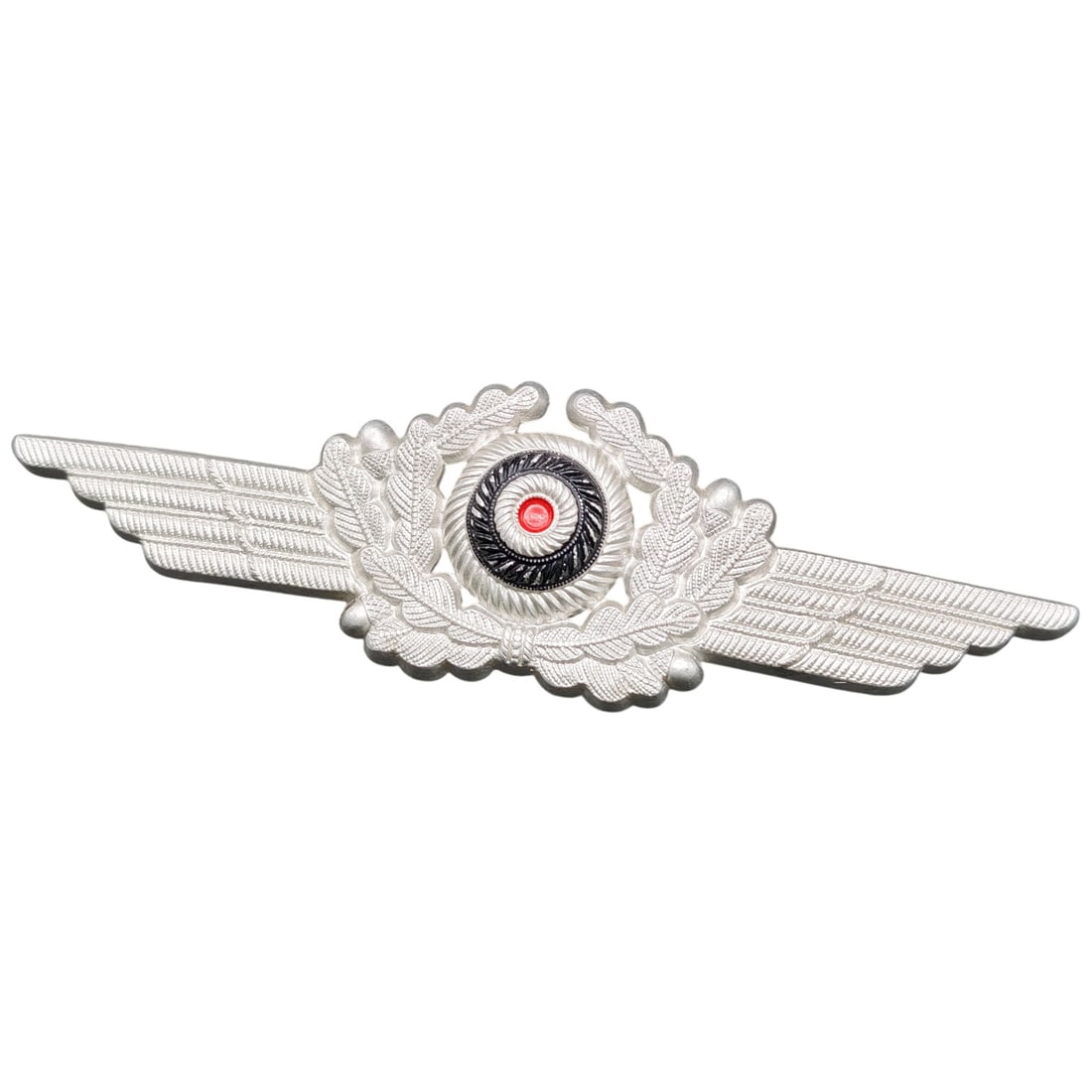 German Luftwaffe-Style Visor Cap Wreath and Cockade Insignia: A winged oak-leaf wreath cap badge with central cockade insert, metal finish in what appears to be silver-tone, featuring red, white, and black enamel-style cockade center. The design is consistent wi