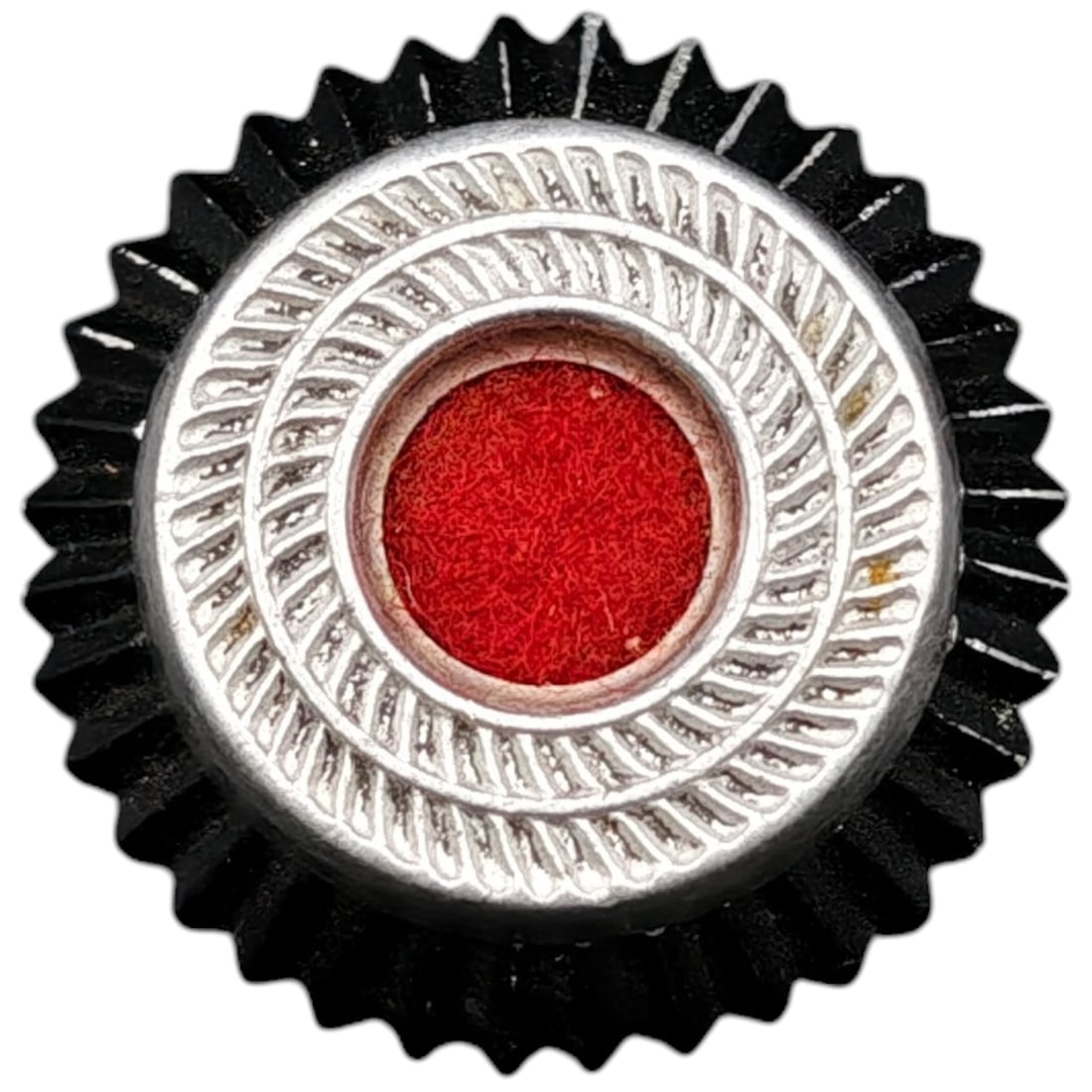 German WWII Heer/Waffen Cockade Cap Insignia: A German military cap cockade featuring a scalloped black outer disc, a middle ring in what appears to be silver-tone sunburst/rope-pattern, and a red center field. The reverse shows a faint stamped n