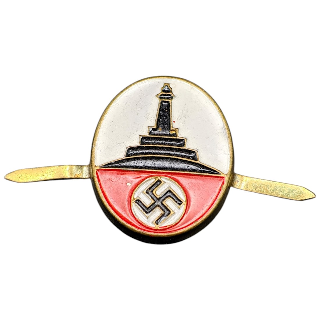 Third Reich Nazi Veterans Association Cap Insignia: Enameled cap insignia depicting the Kyffhäuser Monument tower in black over a red field with a central swastika roundel, set against a white oval enamel ground with a border in what appears to be gil