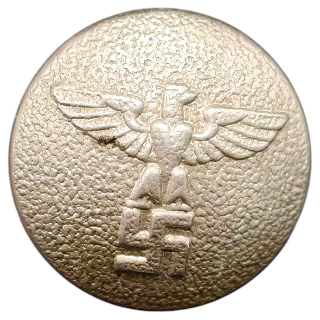 German WWII NSDAP Uniform Button: A single-piece metal uniform button featuring the party eagle clutching a swastika within a wreath (wreath not visible in image), of the type used on NSDAP or affiliated organization tunics and