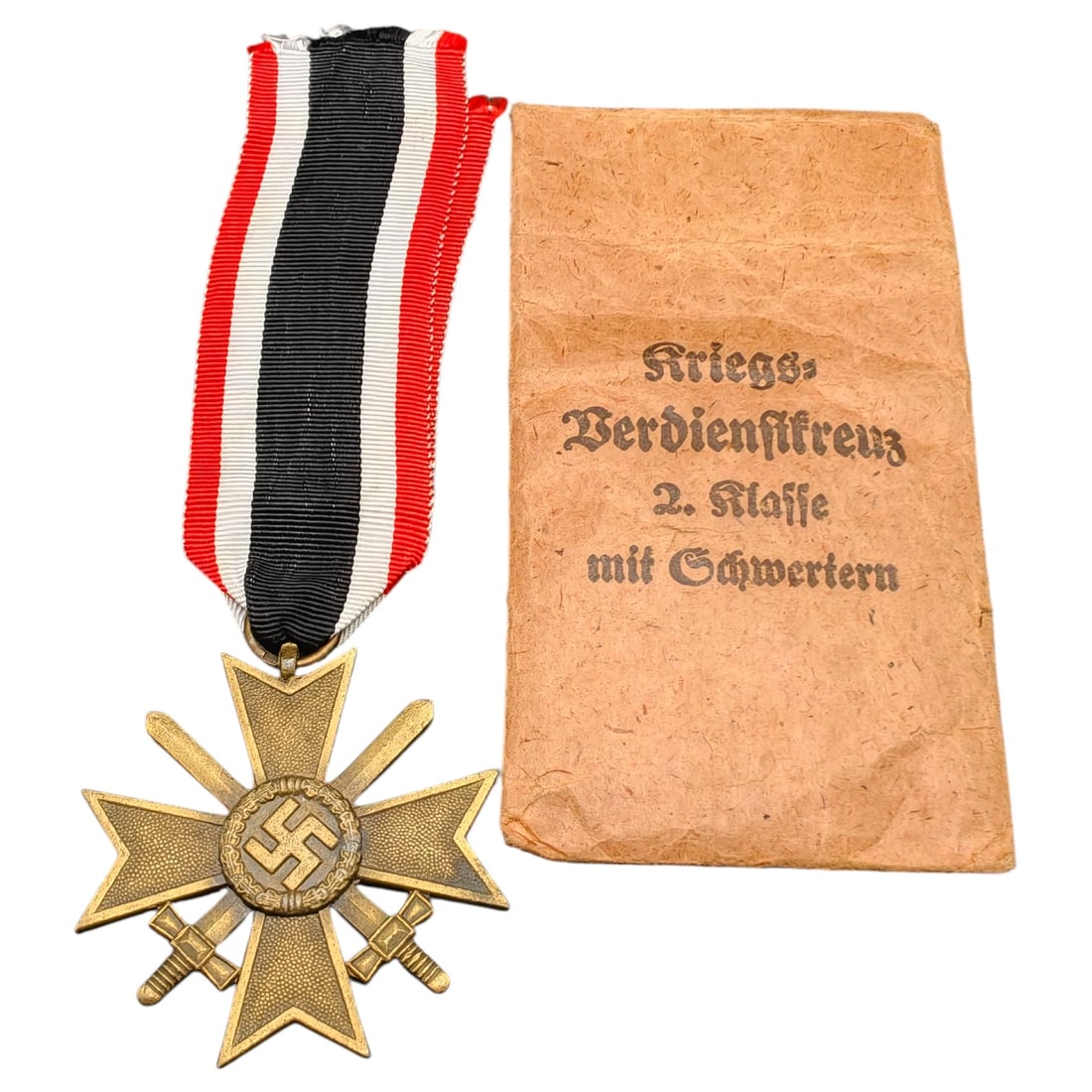 Third Reich War Merit Cross with Envelope: A German Kriegsverdienstkreuz 2. Klasse mit Schwertern (War Merit Cross 2nd Class with Swords), a cross in what appears to be bronze-toned metal with central swastika medallion and crossed swords, sus