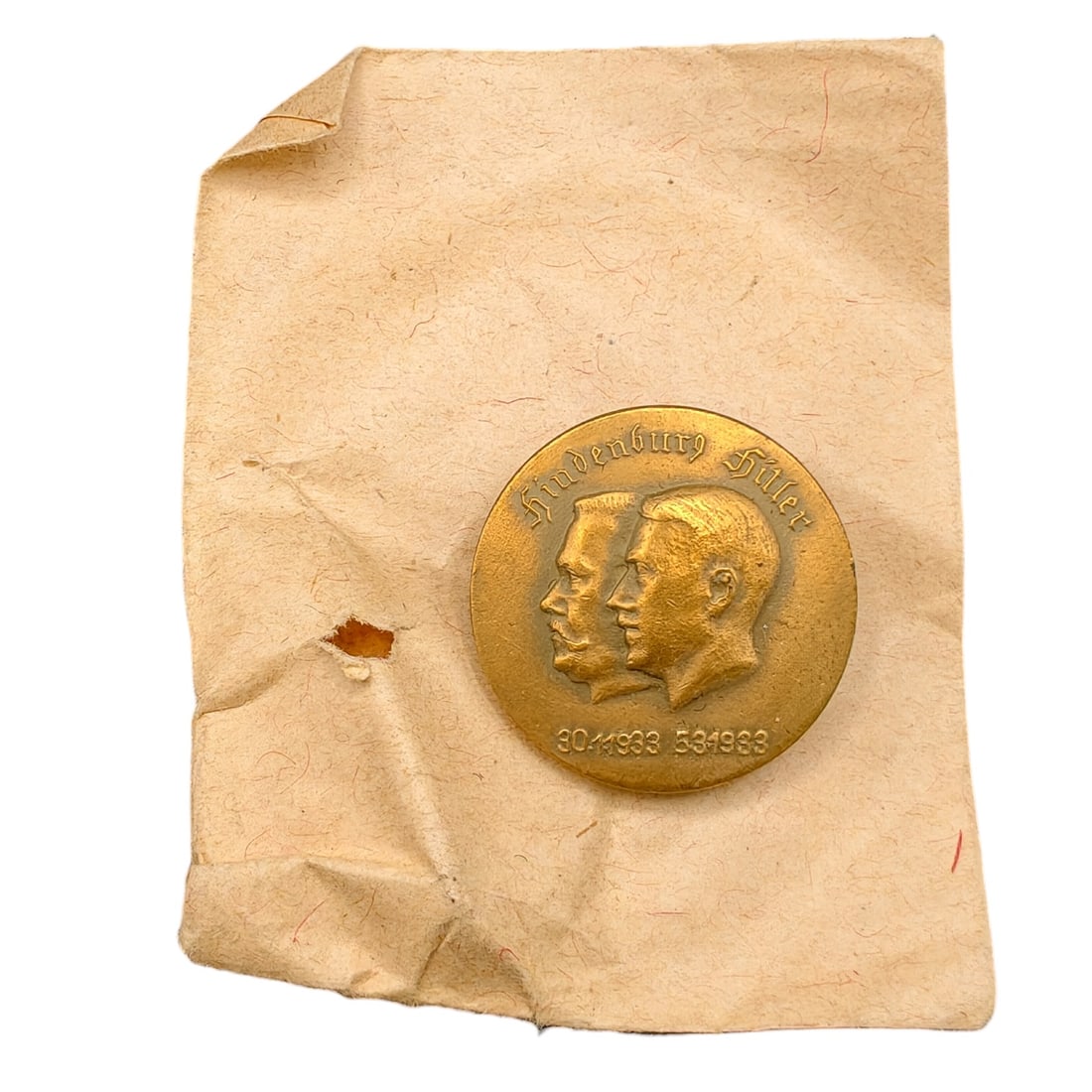 Adolf Hitler Hindenburg Commemorative Badge with Envelope: A round tinnie-style commemorative badge depicting the conjoined profiles of Paul von Hindenburg and Adolf Hitler, inscribed 'Hindenburg Hitler' above and dated '30.1.1933' and '5.3.1933' below, marki