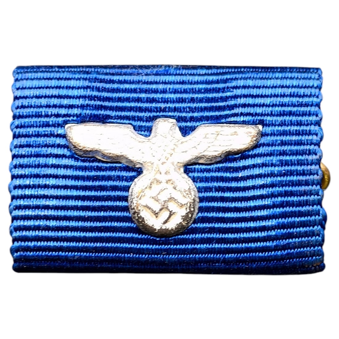 Third Reich Nazi Single-Place Ribbon Bar with Eagle Device: A single-place ribbon bar mounted on a frame in what appears to be metal with blue moire ribbon, affixed with an eagle and swastika device in what appears to be silvered finish. Likely awarded for fou