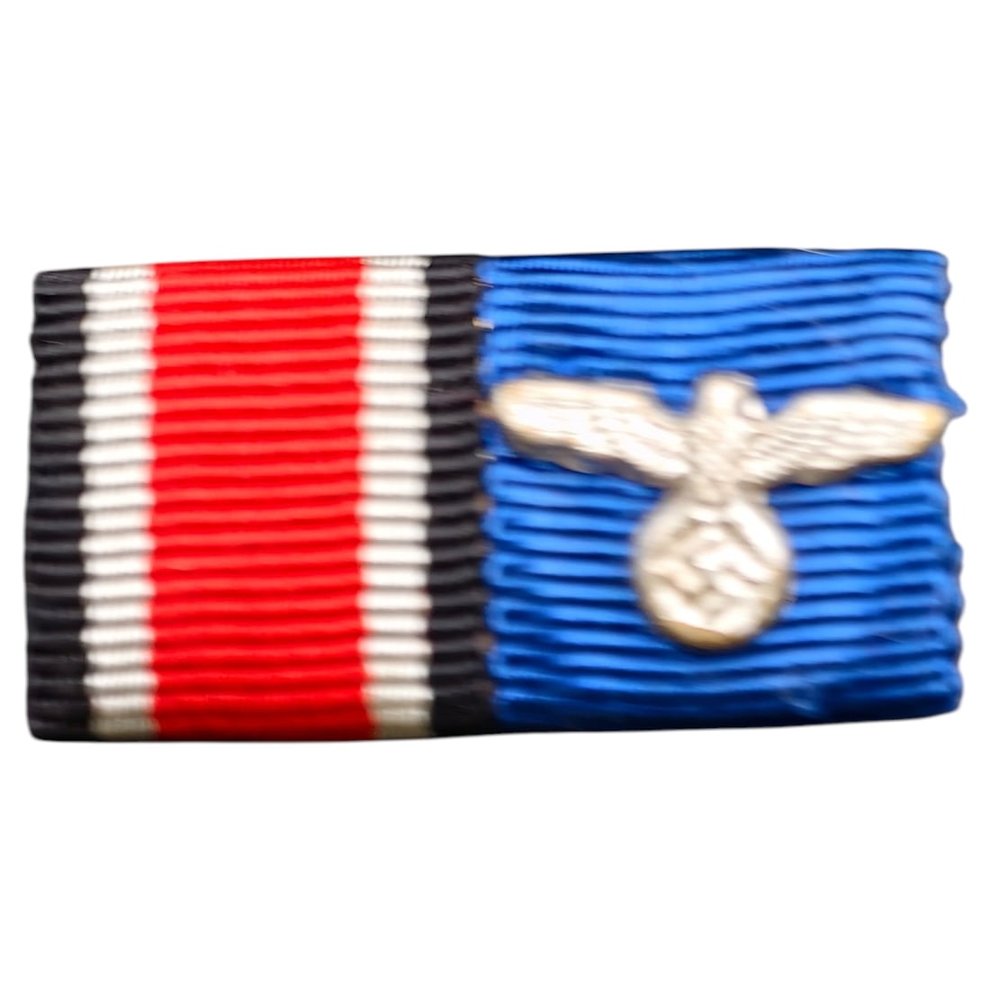 German WWII 2-Place Ribbon Bar - Iron Cross 2nd Class + Service Ribbon with Eagle Device: A two-place ribbon bar mounted on a frame, comprising the Iron Cross 2nd Class ribbon (black-white-red) and a blue service ribbon affixed with a small NSDAP-style eagle and swastika device in what app