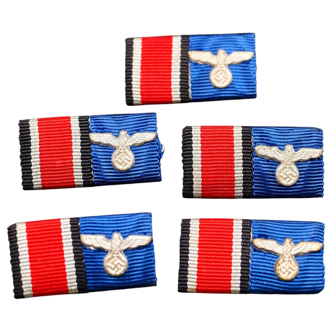 Third Reich Ribbon Bar Set (Iron Cross 2nd Class / War Merit or Long Service Ribbon): Set of identical two-place ribbon bar mounts, each combining the Iron Cross 2nd Class ribbon (black-white-red) with the Wehrmacht Long Service or War Merit blue ribbon segment, affixed with a stamped 