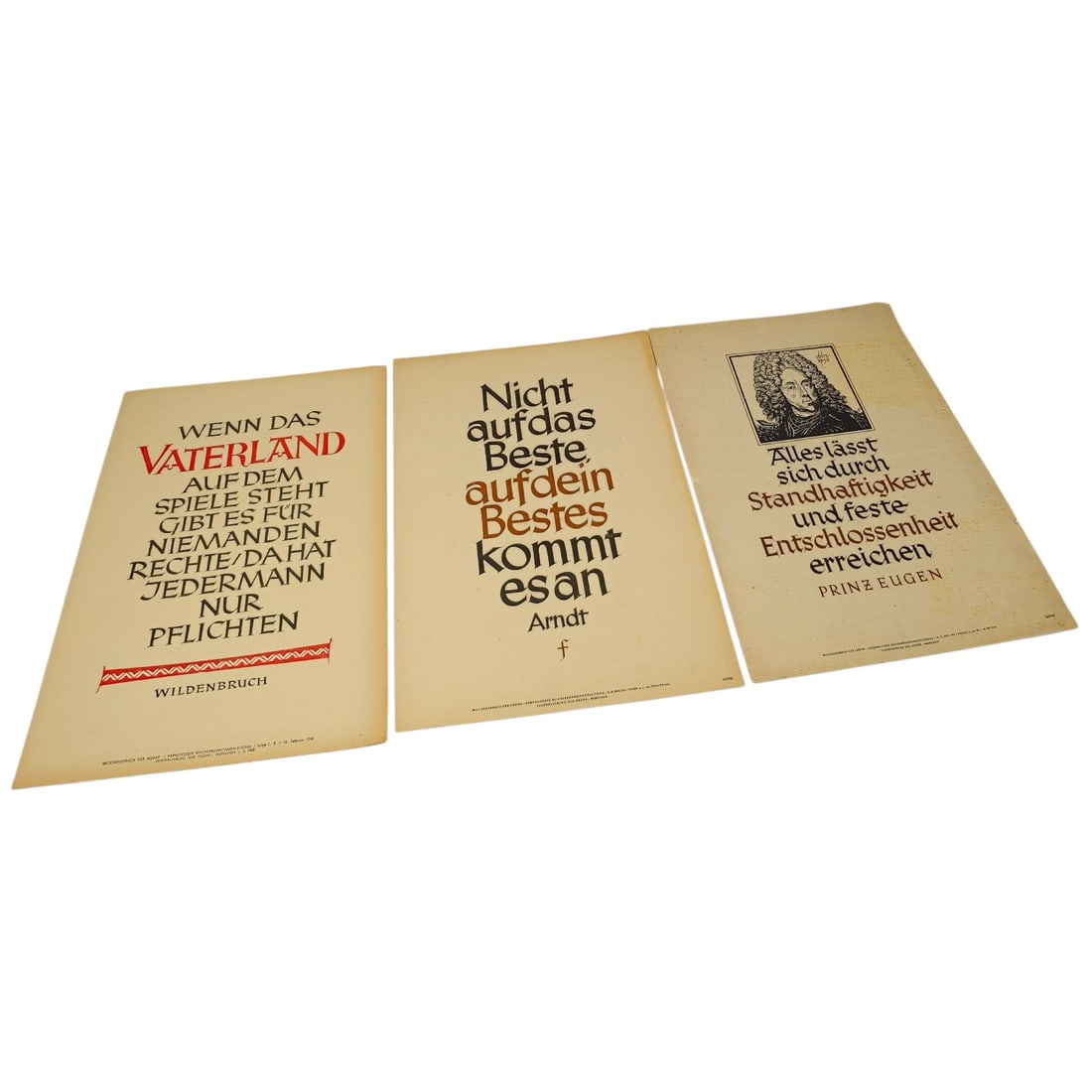 German WWII Wochenspruch der NSDAP Weekly Slogan Sheets - Set: A set of printed weekly slogan sheets (Wochenspruch der NSDAP), each featuring a quotation attributed to historical German figures (Friedrich der Große, Gorch Fock, and Ulrich von Hutten) with styliz