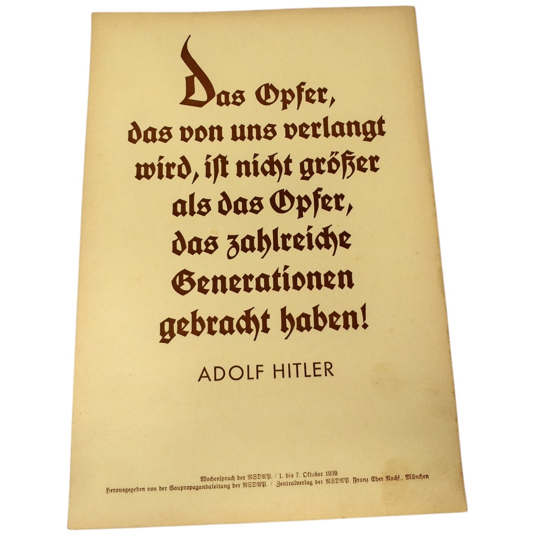 German WWII 'Wochenspruch der NSDAP' Propaganda Wall Sheet, Dated 1939: A single-sheet weekly propaganda quotation ('Wochenspruch der NSDAP') printed in Fraktur script, attributed to Adolf Hitler, dated to the week of 1-7 October 1939. Printer credit at lower margin reads