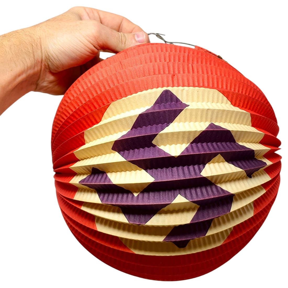 Third Reich Nazi NSDAP Paper Lantern: Accordion-style folding paper lantern in red with cream and purple panels forming a swastika design, likely used for festive or Party-related outdoor decoration during the Third Reich era. Wire