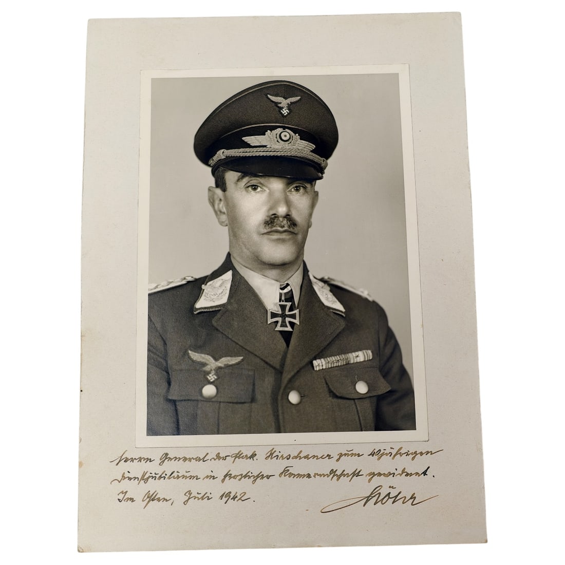 WWII German Luftwaffe General's Signed Studio Portrait Photograph with Dedication, 1942: Large mounted studio portrait photograph of a Luftwaffe General wearing visor cap with eagle and cockade insignia, Knight's Cross of the Iron Cross at the collar, and ribbon bar. The mount bears a han