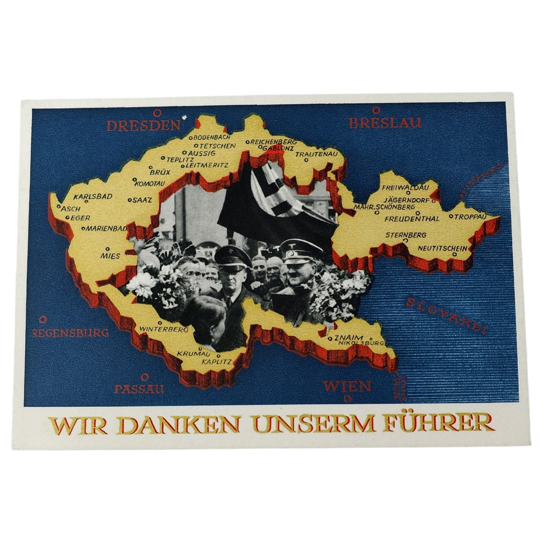Third Reich Nazi Postcard: Propaganda postcard commemorating the annexation of the Sudetenland, featuring a stylized map of the region with towns labeled and a photographic inset of Hitler receiving flowers before a swastika
