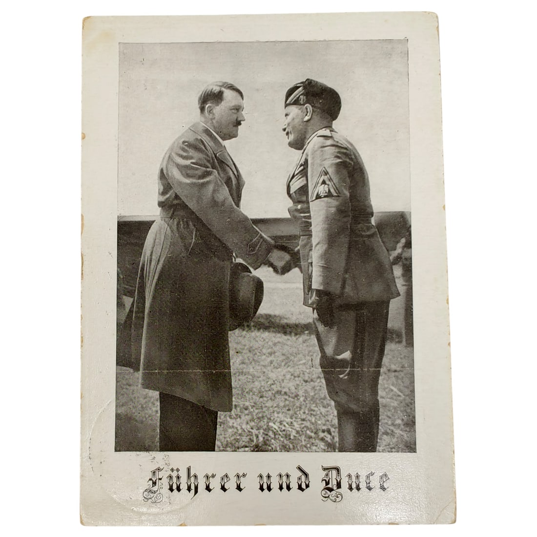 German WWII Propaganda Postcard "Führer und Duce" - Hitler and Mussolini: A period photographic propaganda postcard depicting Adolf Hitler shaking hands with Benito Mussolini, captioned 'Führer und Duce' in Fraktur script. Printed by R. Schlothauer i. Leipzig as noted on