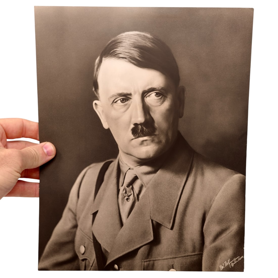 HUGE Adolf Hitler Heinrich Hoffmann Portrait Photograph: A large sepia-toned studio portrait photograph of Adolf Hitler in party uniform with tie and Iron Cross ribbon. The lower right corner bears the printed photographer credit 'Hoffmann' indicating a
