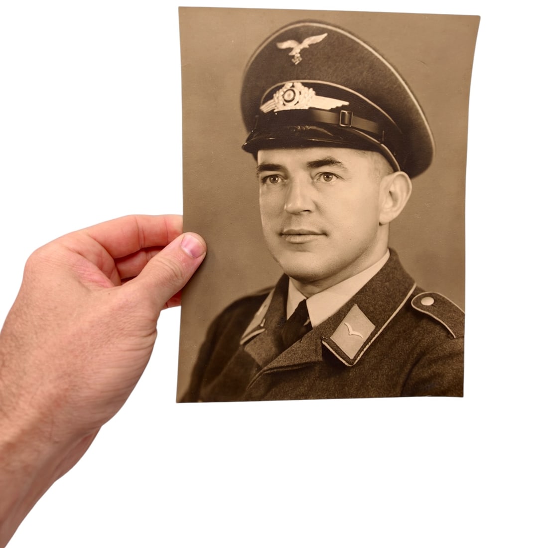 Luftwaffe Officer Studio Portrait Photograph: Original studio portrait photograph of a Luftwaffe officer wearing a visor cap with eagle and cockade insignia, and a service tunic with collar tabs bearing the Luftwaffe wing/bird device. No visible 