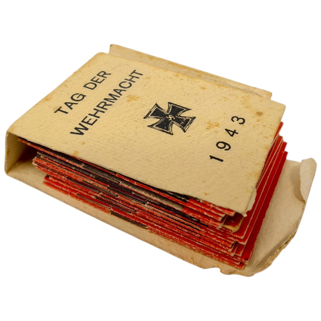 German WWII 'Tag der Wehrmacht' 1943 Card Booklet Set with Knight's Cross Recipients: A small paper sleeve printed 'Tag der Wehrmacht 1943' with an Iron Cross graphic, containing a stack of miniature portrait cards of German servicemen, including one identified as 'Hellmuth Arpke', a K