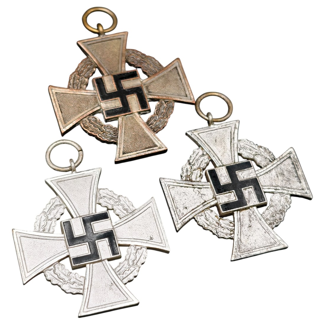 German WWII 25 Year Faithful Service Medal Set: Set of German Faithful Service Crosses (Treudienst-Ehrenzeichen), Third Reich Period This set comprises crosses awarded for long and faithful service in the civil administration and public sector duri