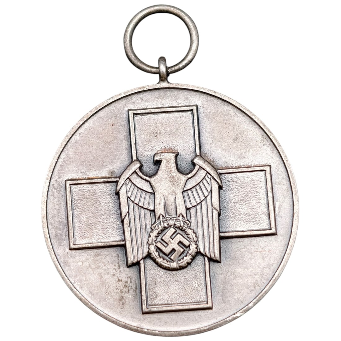 German WWII 'Medaille für deutsche Volkspflege' (Social Welfare) Medal: A round medal in what appears to be a silvered white metal, featuring a central cross design with an eagle clutching a wreathed swastika at the center. The reverse bears the raised Gothic-script inscr