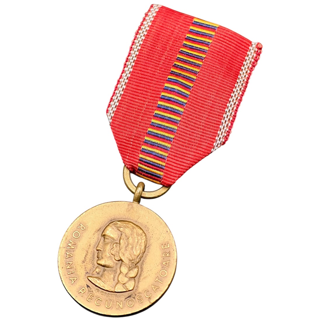 Romanian WWII "Crusade Against Communism" Medal, 1941: A Romanian campaign medal in what appears to be gilt bronze, suspended from a red moiré ribbon with narrow yellow, blue, and red stripes and white edge borders. One face bears a female profile bust w