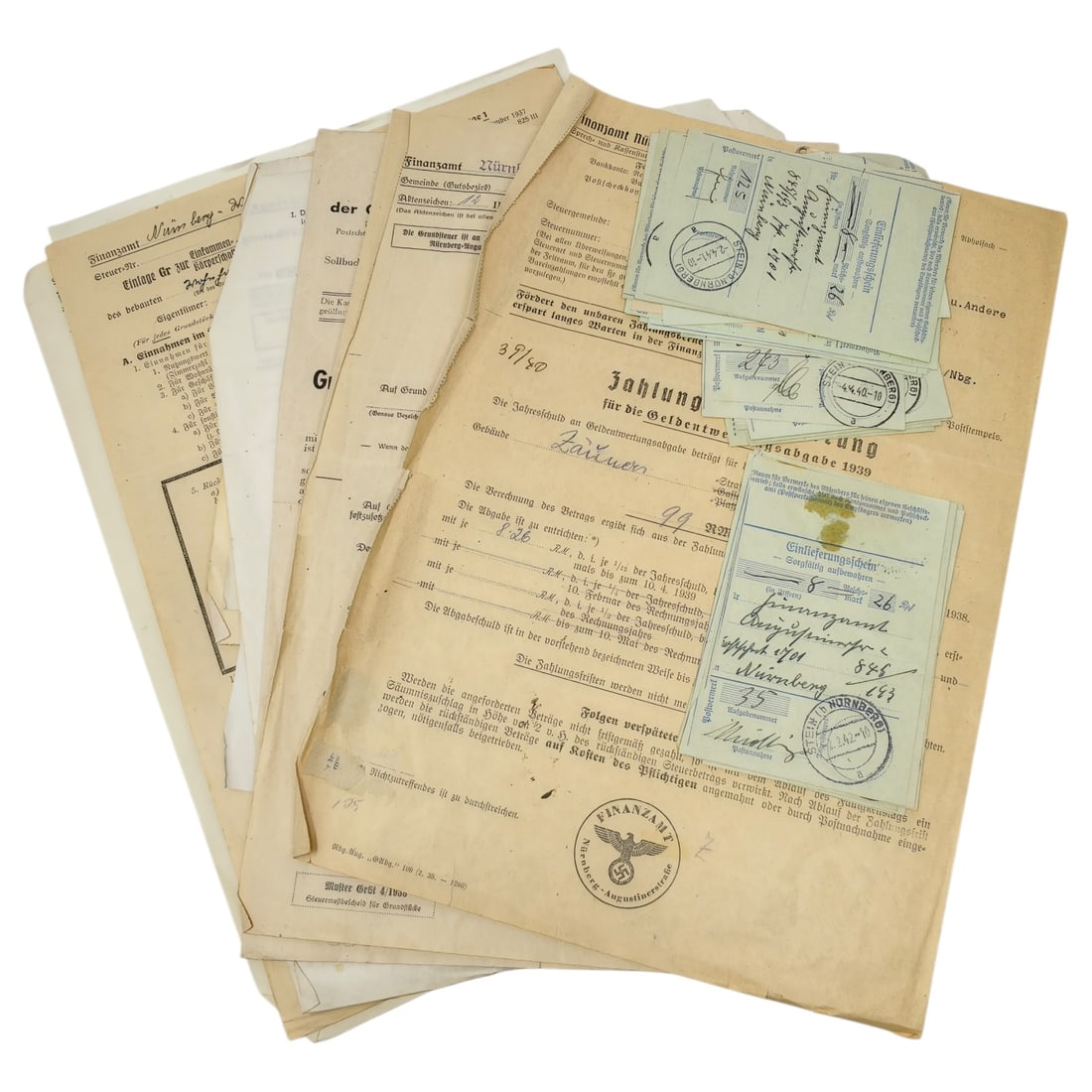 German WWII Third Reich Finanzamt Nürnberg Tax Document Set: A set of German tax office (Finanzamt Nürnberg) documents dating to the late 1930s and early 1940s, including a Grundsteuermeßbescheid 1938 (land tax assessment notice) and related