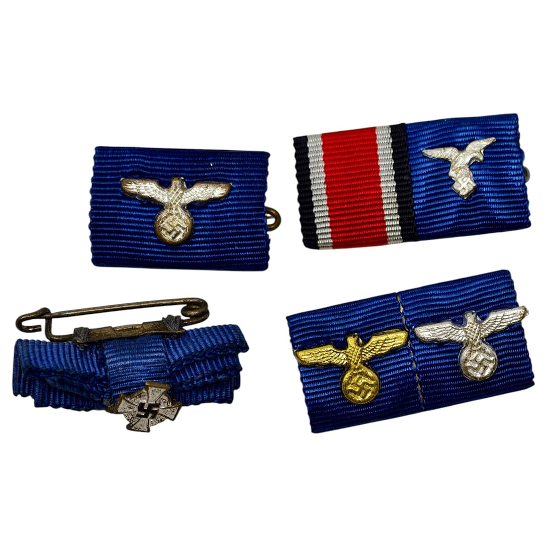 Set of German WWII Long Service Award Ribbon Bars with Eagle Devices: A set of ribbon bars mounted on blue moiré ribbon for the Wehrmacht/NSDAP Long Service Awards, each fitted with a stamped eagle-and-swastika device in silvered or gilt finish. One bar combines the lo