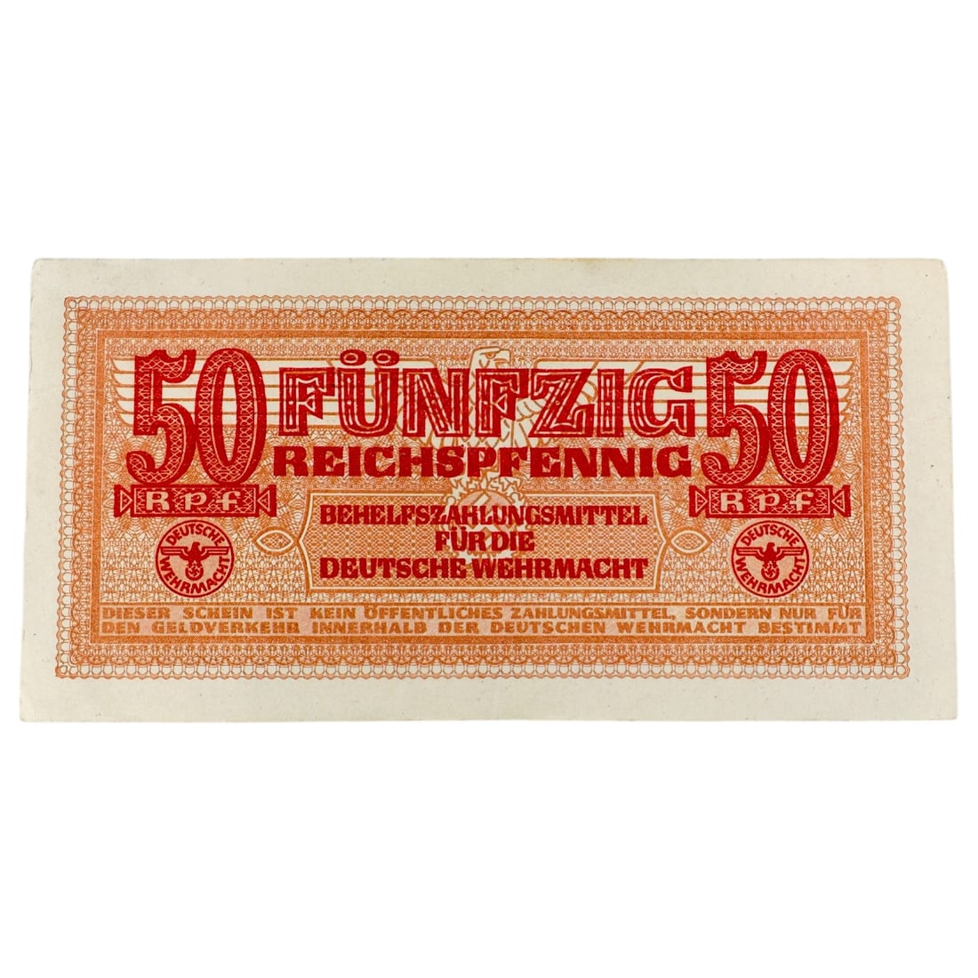 German WWII Wehrmacht 50 Reichspfennig Military Payment Note: A 50 Reichspfennig "Behelfszahlungsmittel für die Deutsche Wehrmacht" military payment certificate, printed in orange and red with the denomination "50 FÜNFZIG REICHSPFENNIG" repeated across