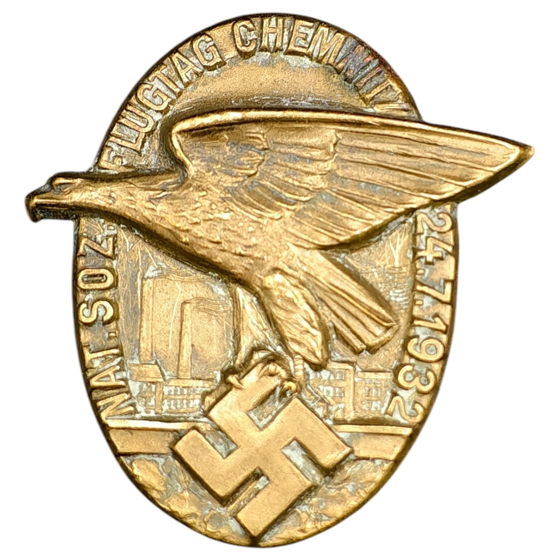 German 'Flugtag Chemnitz' 1932 NSDAP Tinnie Badge: An oval tinnie badge commemorating the 'Flugtag Chemnitz' aviation day held 24.7.1932. The badge depicts a large bird of prey in flight over a stylized cityscape, with a swastika device below, and bea