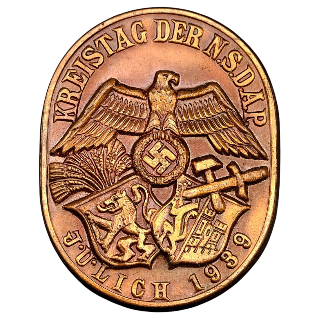 German Third Reich "Kreistag der NSDAP – Jülich 1939" Commemorative Tinnie: An oval commemorative badge inscribed "KREISTAG DER N.S.D.A.P." around the top edge and "JÜLICH 1939" along the lower edge, believed to be a copper alloy. The central design features an eagle with wi