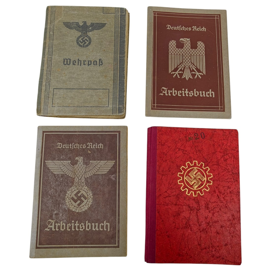 Set of German WWII Identity Documents – Wehrpass, Arbeitsbuch, and DAF Book: This set brings together a Wehrpass military service record book with an eagle and swastika emblem above the title, two Arbeitsbuch labor record booklets each bearing the Deutsches Reich eagle insigni
