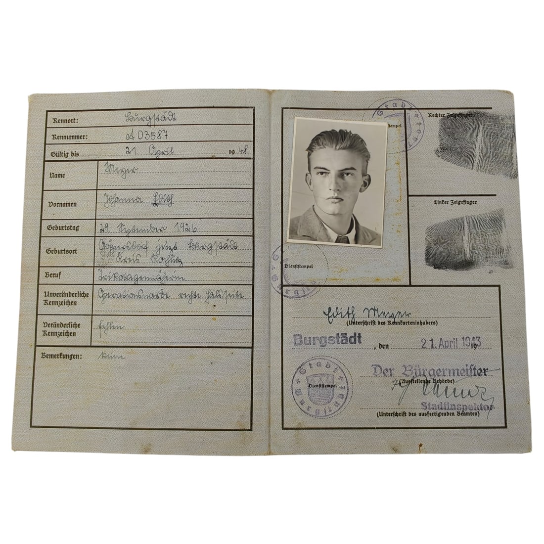 German WWII Deutsches Reich Kennkarte - Burgstädt: A Third Reich period identity document (Kennkarte) issued to a male holder from Burgstädt, with printed cover bearing the Deutsches Reich eagle and swastika emblem. The interior pages record personal