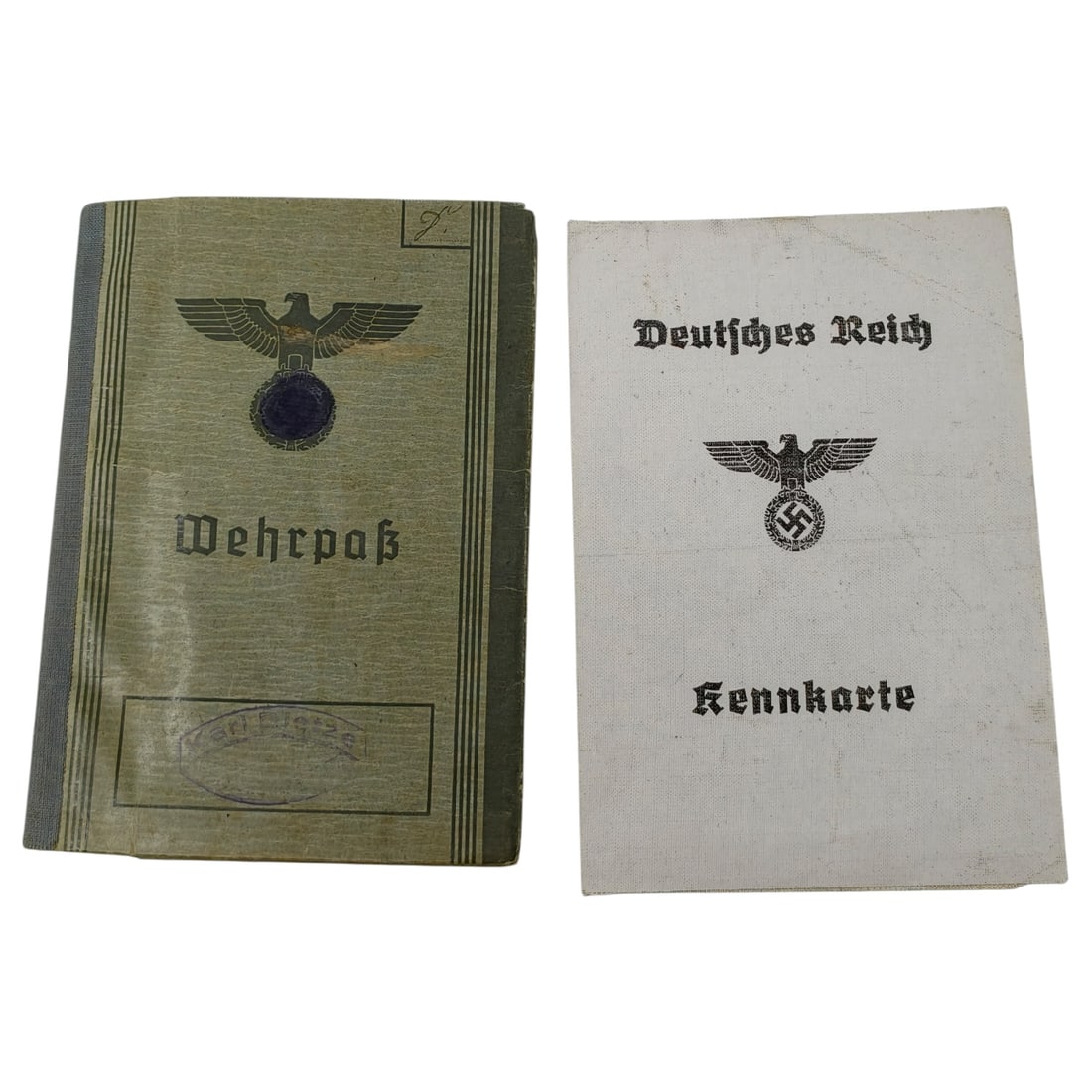 German WWII Wehrpass and Kennkarte Document Set with DRK Membership Card: A Wehrmacht Wehrpaß (military service pay/identity book) in a green covered binding with a stylized eagle and swastika emblem on the front cover, paired with a Deutsches Reich Kennkarte identity book