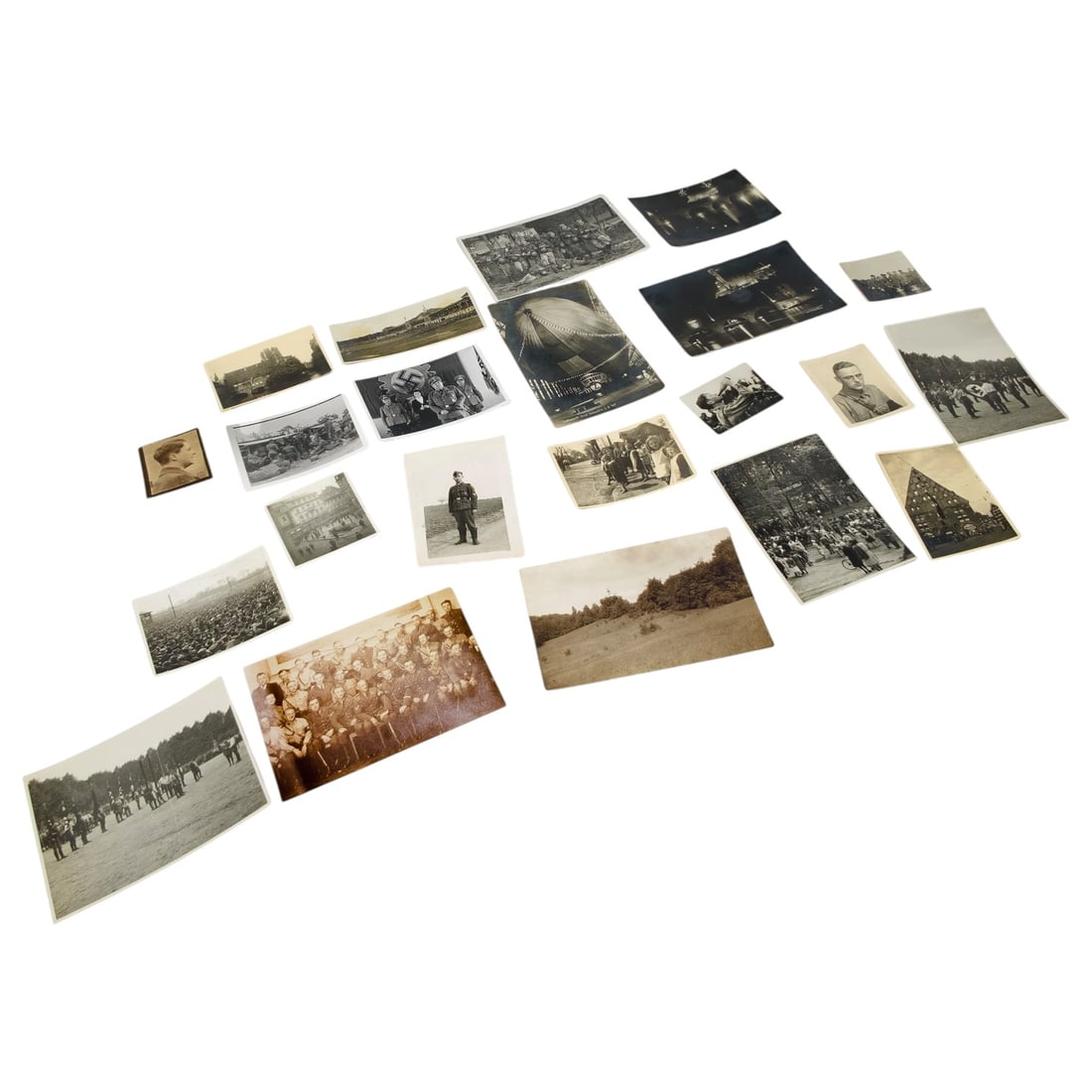 Set of Third Reich Era German Photographs and Postcards: A set of period photographs and postcards depicting German military and civilian life, including group portraits of uniformed servicemen, individual soldier portraits, mass rally and parade scenes, a 