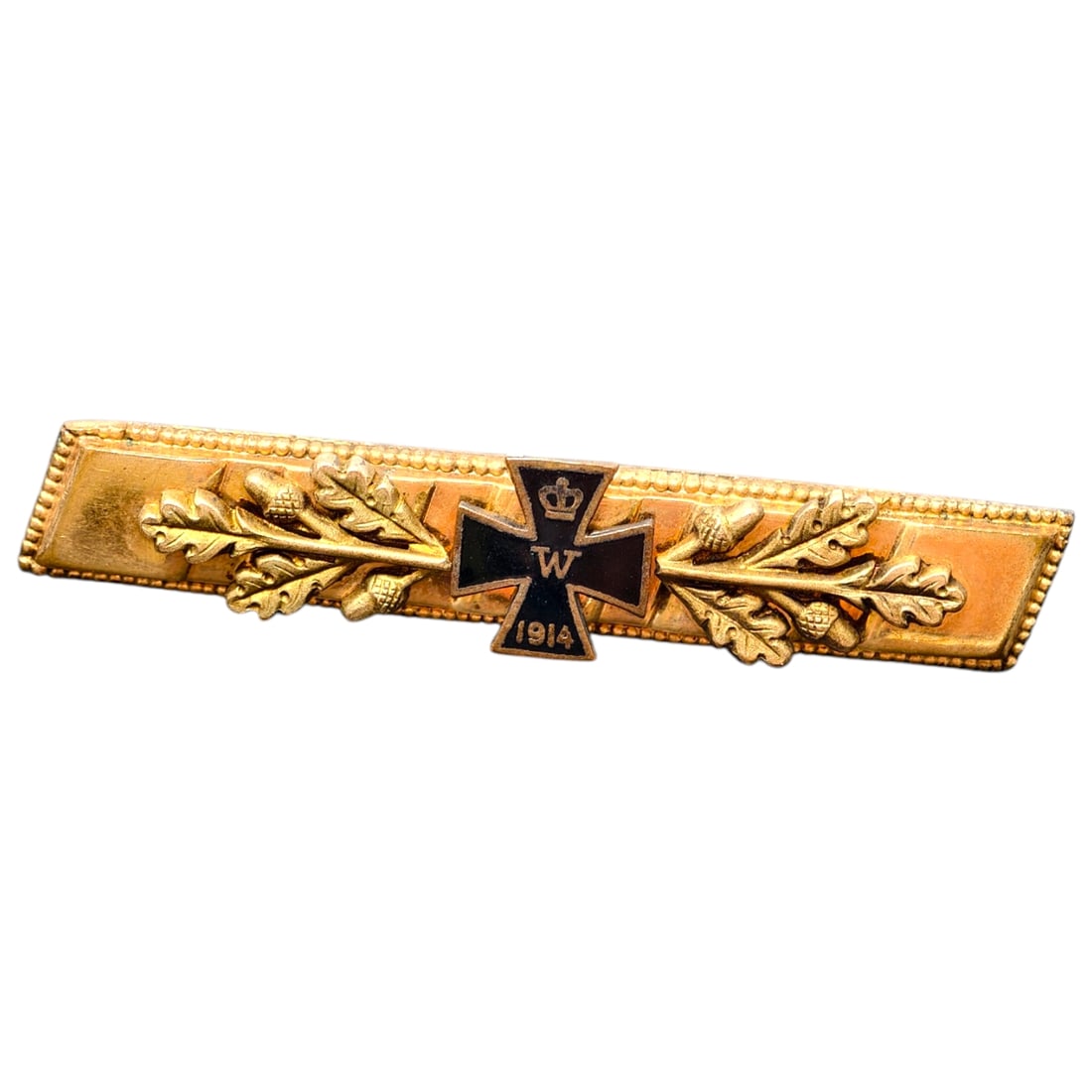 Imperial German 1914 Iron Cross Commemorative Tie/Lapel Bar Pin: A gilt-finish bar brooch centered with a black-enameled Iron Cross bearing a crowned "W" cipher and the date "1914", flanked by oak leaf and acorn sprays. The rectangular frame has a beaded border, an