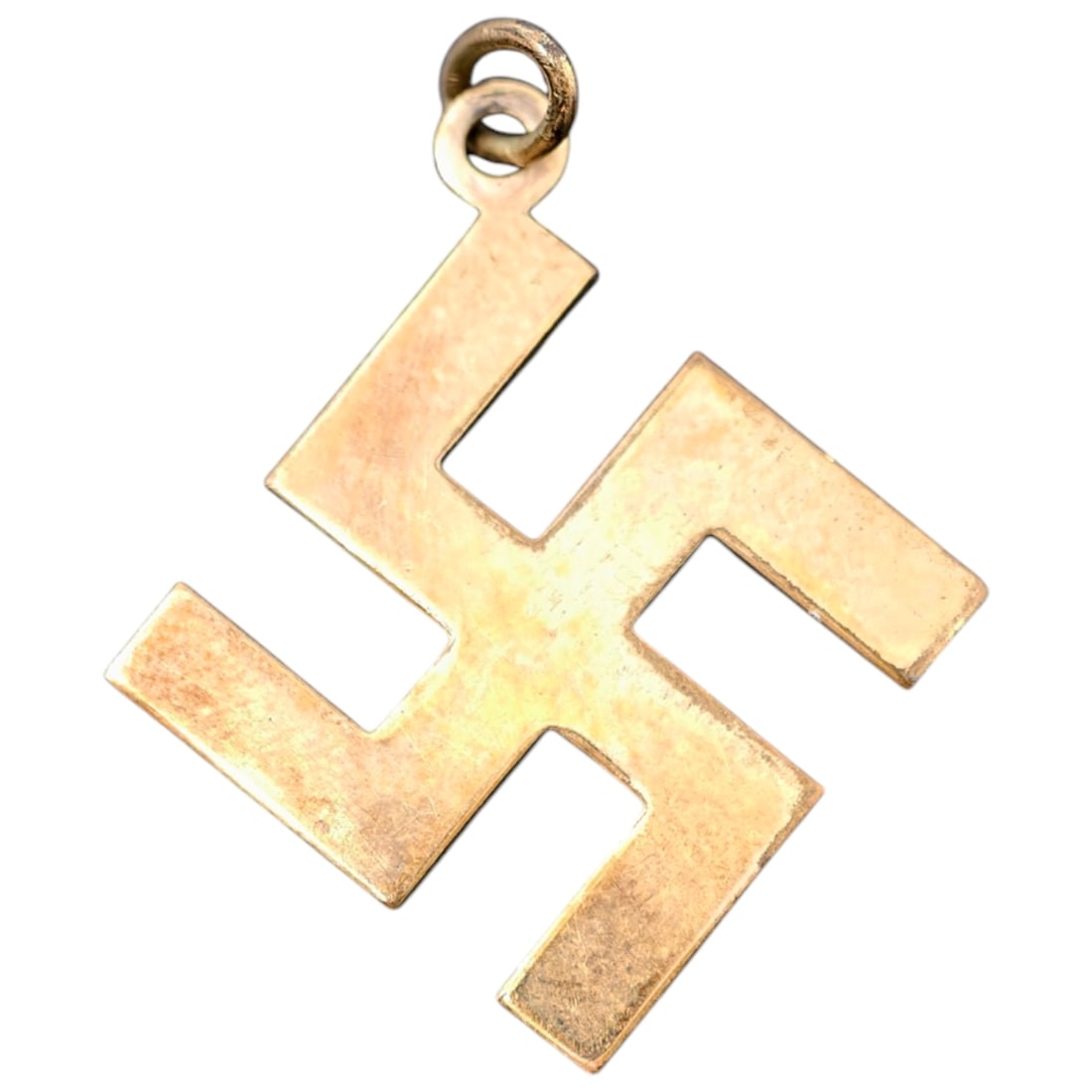 German Third Reich Swastika Pendant: Early Swastika-Form Pendant in Yellow MetalA small pendant in the form of a swastika, worked in a yellow metal believed to be gold, with a plain suspension loop at one point. The piece is unmarked and