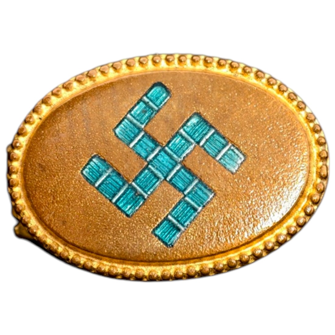 Oval Swastika Badge: An oval badge in a gilt-toned metal with a beaded border surrounding a raised swastika motif finished in a turquoise enamel-like color.