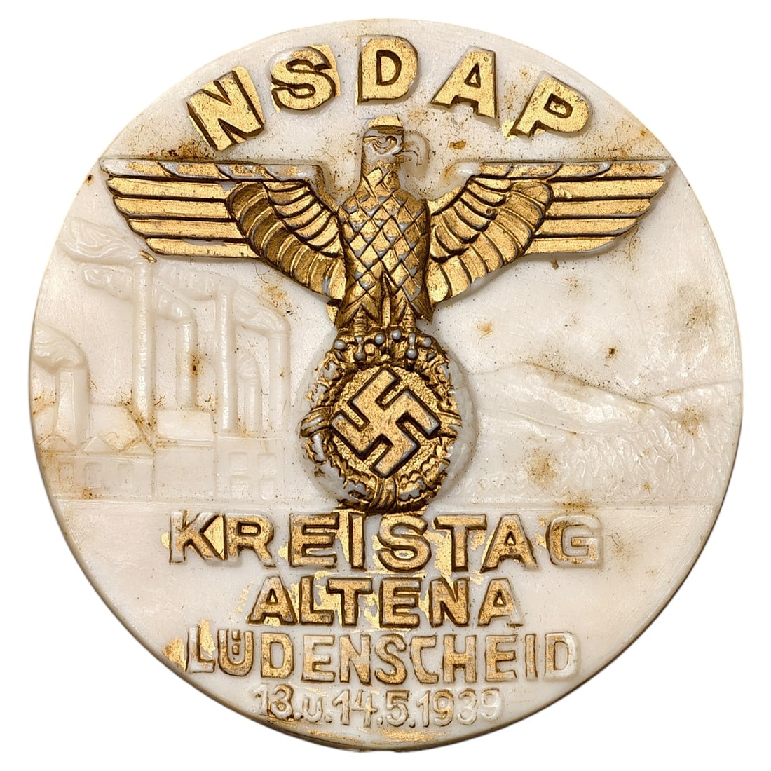 NSDAP Kreistag Altena-Luedenscheid 1939 Tinnie Badge: A round commemorative badge issued for the NSDAP Kreistag rally held in Altena and Luedenscheid on 13 and 14 May 1939. The face is molded in a pale material, likely a pressed composition, with a raise
