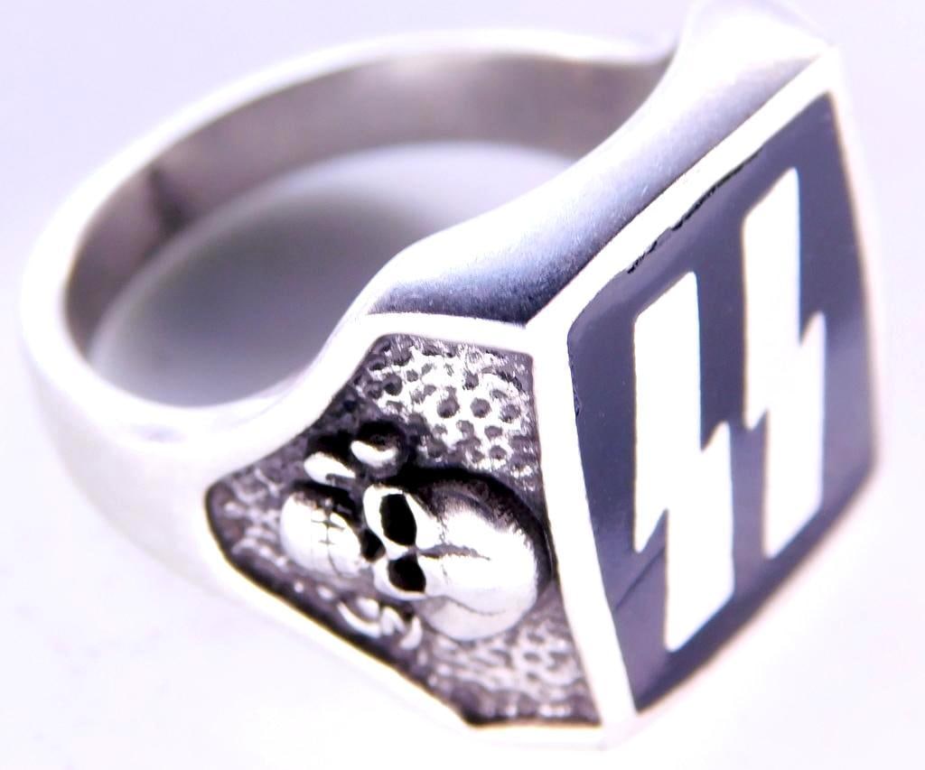 German WWII Waffen SS Officers Runic and Skull Ring: Front shows a pair of Waffen SS runics in the center flanked by a Waffen SS Totenkopf skull and cross bones on each side. Nickel construction with black enamel. Size 9 3/4.