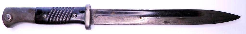 German WWII Mauser K-98 Combat Rifle Bayonet and Scabbard: Steel blade is numbered and maker marked 6189 e Elite-Diamant and has been sharpened. It is also dated 38 on the top of the spine. It measures 1 inch wide by 9 7/8 inches long. Scabbard is numbered an
