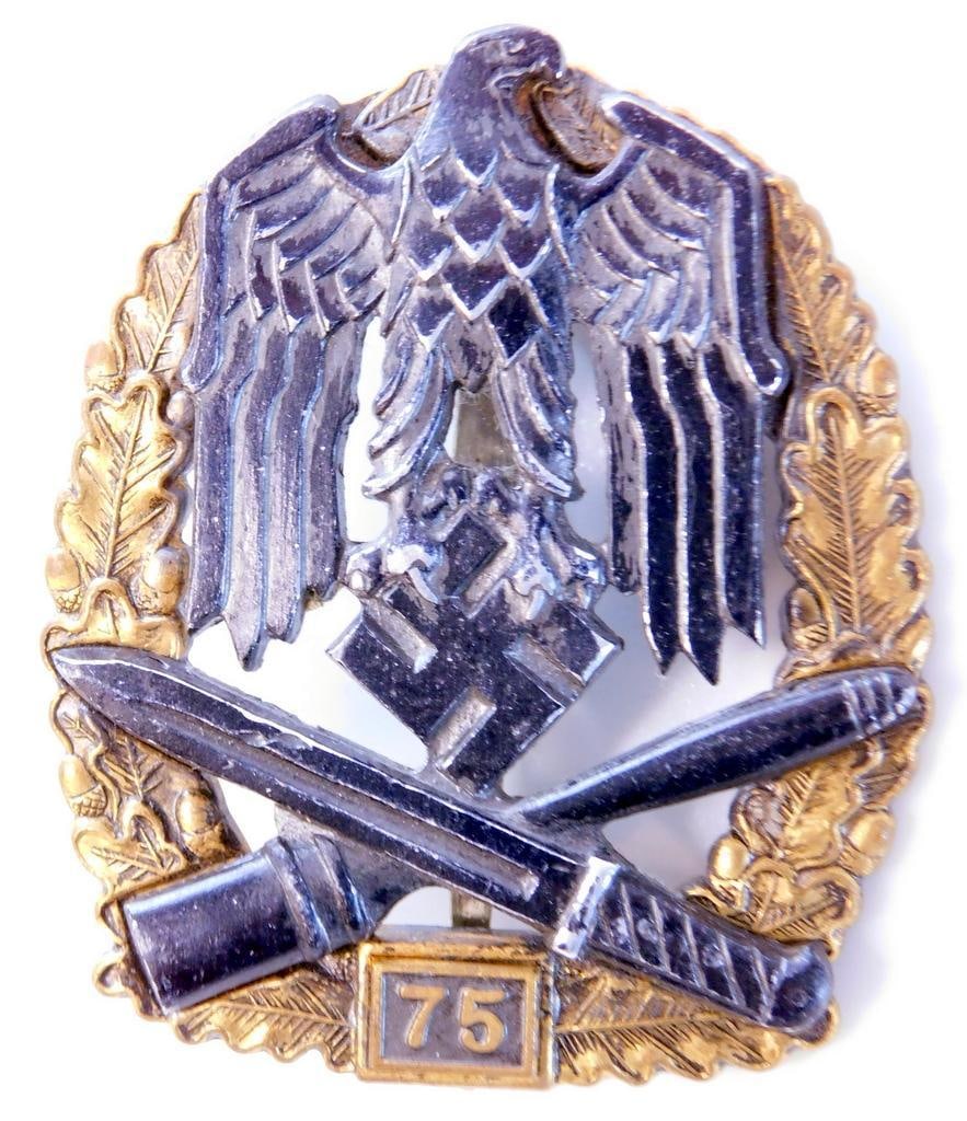German WWII Army HEER 75 General Assault Badge: Two piece die struck four domed rivet brass and nickel construction. Front shows a bold German eagle clutching a swastika in his talons. Below is a crossed bayonet and potato masher stick grenade. All